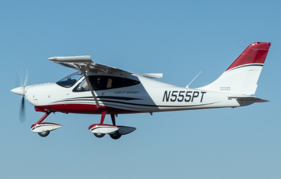 White airplane flying in blue sky